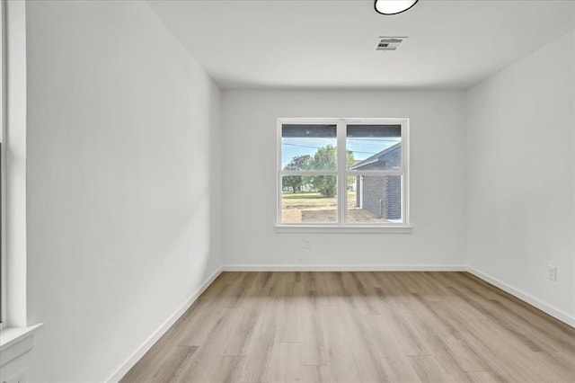 empty room with light hardwood / wood-style flooring