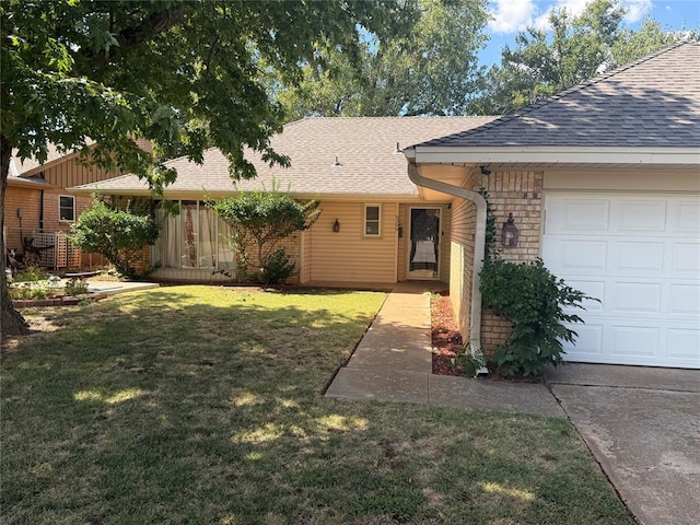 view of front of property featuring a garage and a front lawn