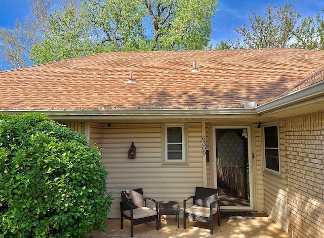 view of exterior entry featuring a patio area