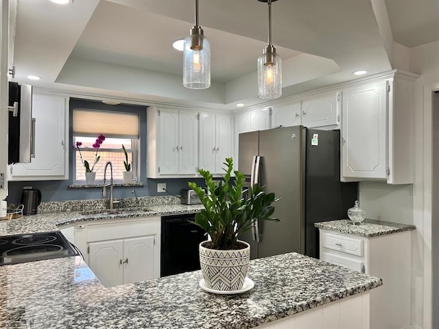 kitchen featuring a raised ceiling, pendant lighting, white cabinets, and stainless steel fridge with ice dispenser