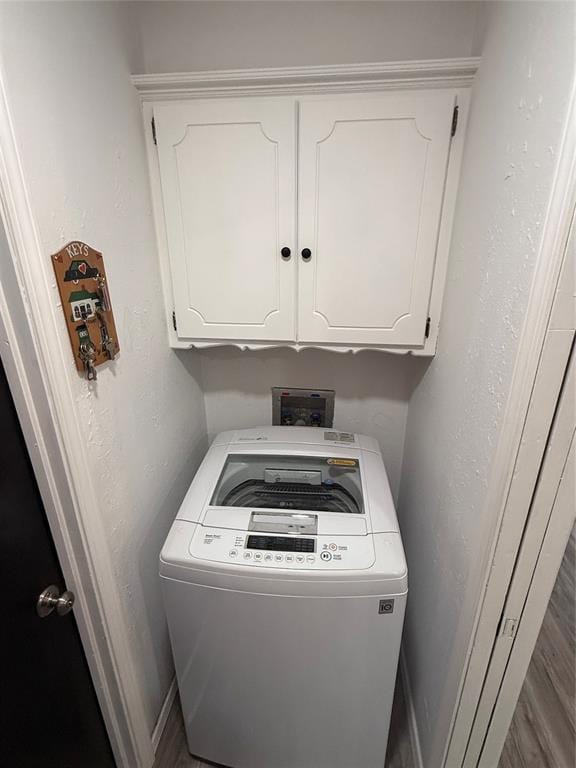 laundry area with washer / clothes dryer and cabinets