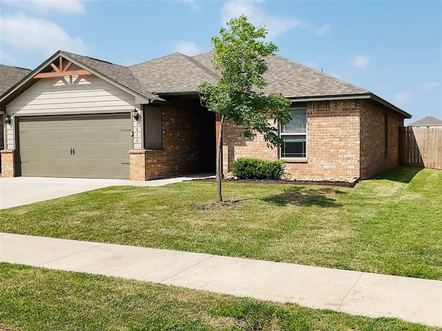 view of front of house with a garage and a front lawn