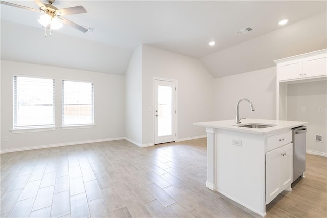 kitchen featuring ceiling fan, visible vents, dishwasher, a sink, and lofted ceiling