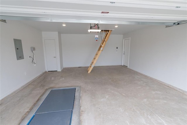 garage with a garage door opener and electric panel