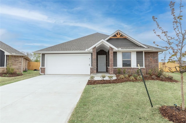 view of front of property featuring an attached garage, a front yard, and brick siding