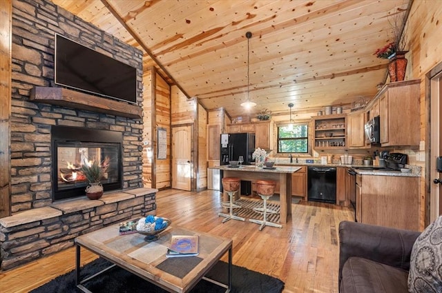 living room with wooden ceiling, high vaulted ceiling, a stone fireplace, wooden walls, and light hardwood / wood-style flooring