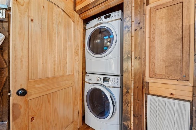 laundry room with stacked washer / dryer