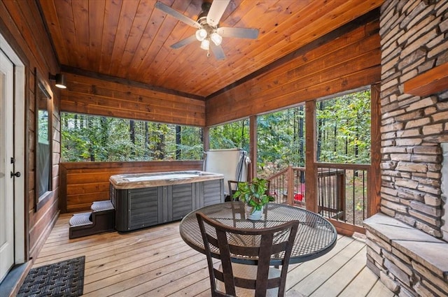 sunroom / solarium with ceiling fan, wooden ceiling, and a hot tub