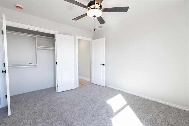 unfurnished bedroom featuring ceiling fan, carpet floors, visible vents, baseboards, and a closet