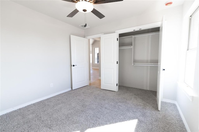 unfurnished bedroom featuring ceiling fan, visible vents, baseboards, a closet, and carpet