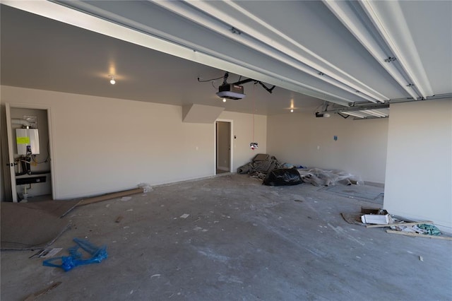 garage with tankless water heater and a garage door opener