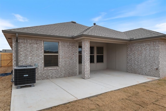 rear view of property featuring a patio area and central air condition unit