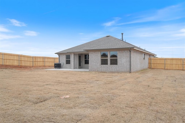 back of property with central AC and a patio