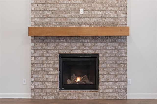 room details with hardwood / wood-style flooring and a brick fireplace