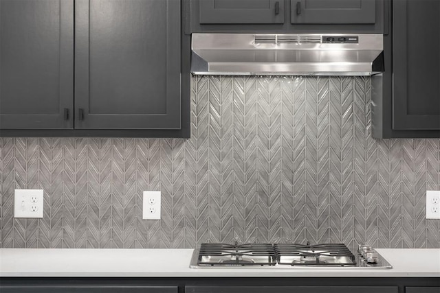 kitchen with backsplash, extractor fan, and stainless steel gas stovetop