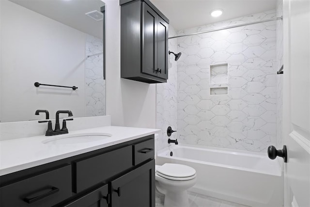 full bathroom featuring vanity, tiled shower / bath combo, and toilet