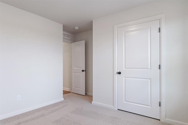 unfurnished bedroom with light colored carpet