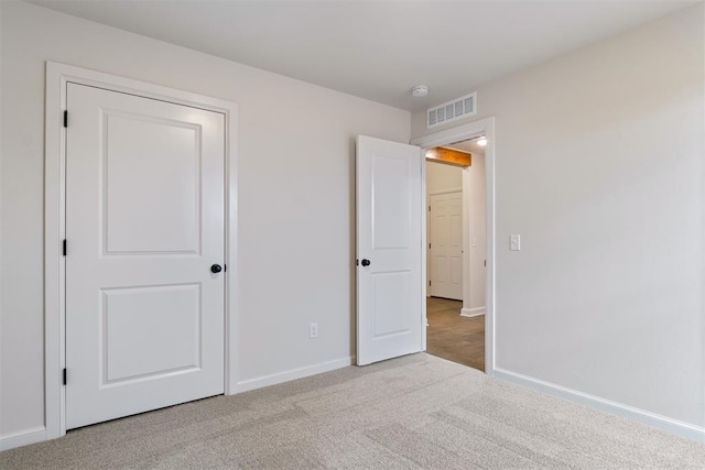 unfurnished bedroom with light carpet