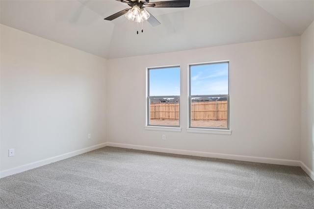 carpeted empty room featuring vaulted ceiling and ceiling fan