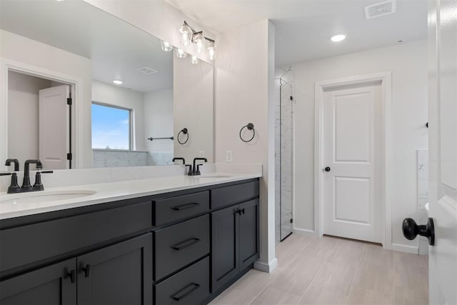 bathroom featuring a shower and vanity