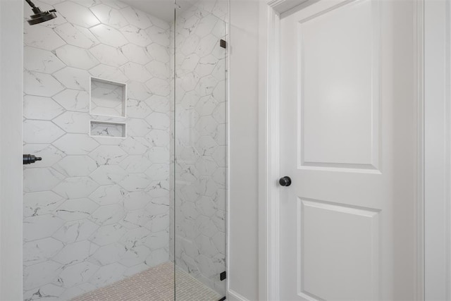 bathroom with a tile shower