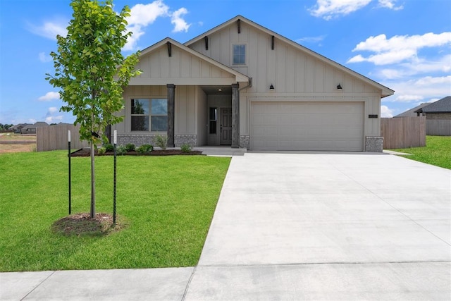 590 Emmy Jean Dr, Blanchard, OK 73010 - view of front of property featuring board and batten siding, concrete driveway, a garage, and brick siding