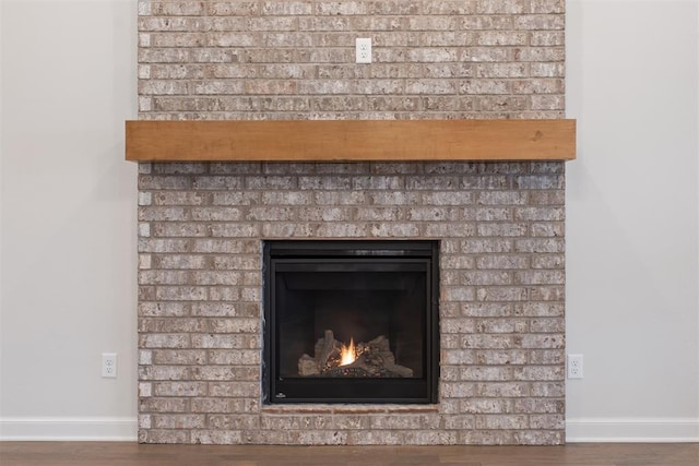 590 Emmy Jean Dr, Blanchard, OK 73010 - detailed view of wood finished floors and a brick fireplace