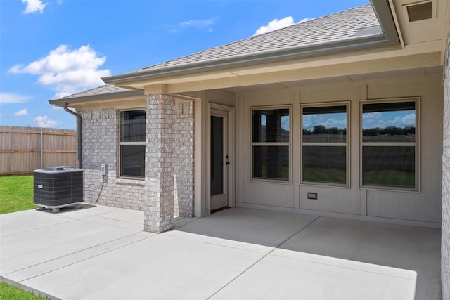 590 Emmy Jean Dr, Blanchard, OK 73010 - view of exterior entry with a patio area, a shingled roof, and brick siding