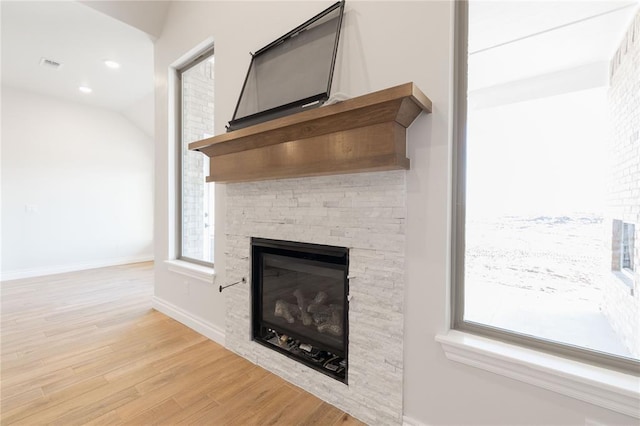 interior details with a fireplace, baseboards, wood finished floors, and recessed lighting