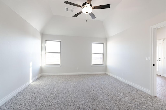 unfurnished room with lofted ceiling, plenty of natural light, visible vents, and baseboards