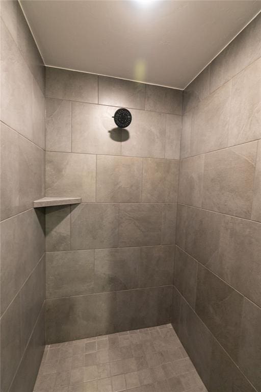 bathroom with a tile shower