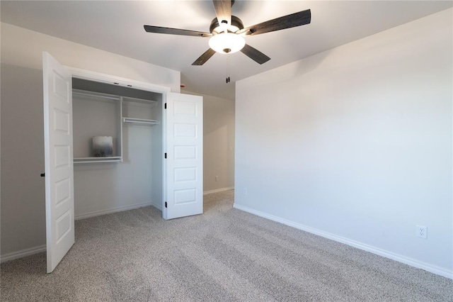 unfurnished bedroom with ceiling fan, a closet, carpet flooring, and baseboards