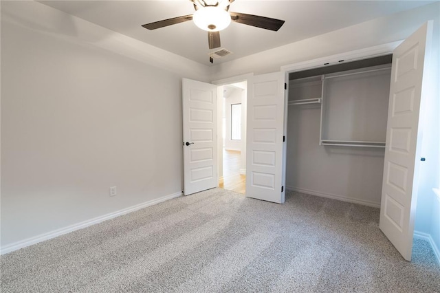 unfurnished bedroom with carpet floors, a closet, visible vents, and baseboards