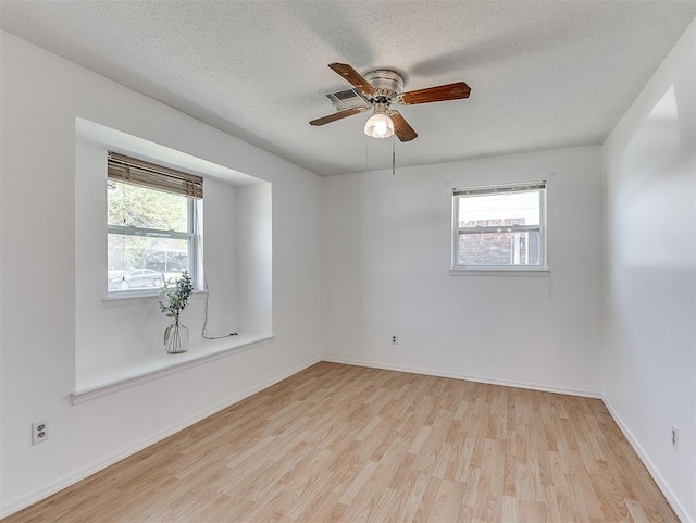 unfurnished room featuring ceiling fan, a textured ceiling, and light hardwood / wood-style flooring