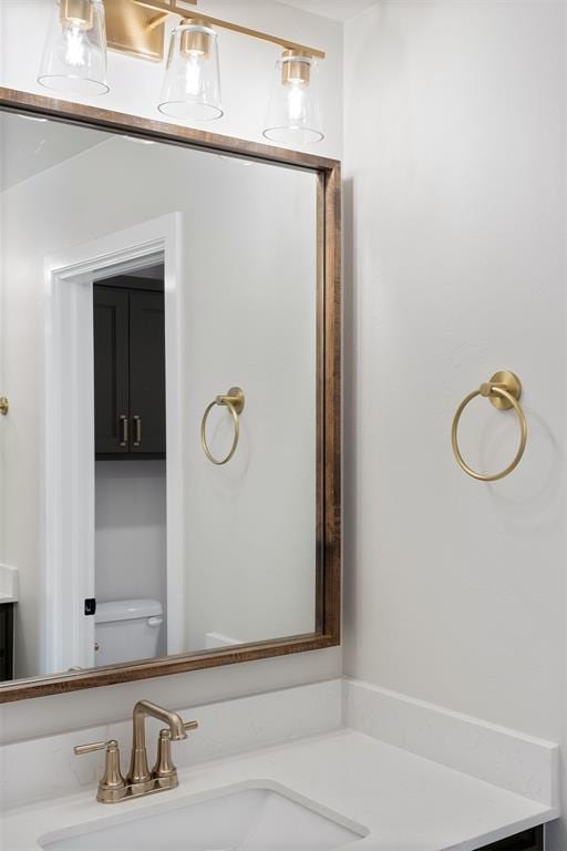 bathroom featuring vanity and toilet