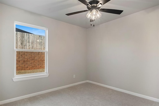 carpeted spare room with ceiling fan