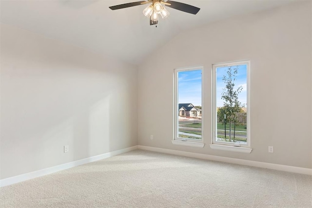 carpeted empty room with ceiling fan and vaulted ceiling