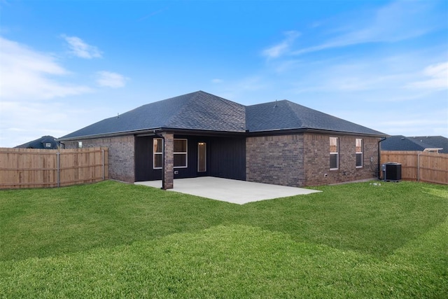 rear view of property featuring central air condition unit, a yard, and a patio