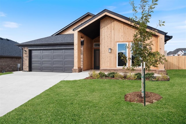 view of front of home with a garage and a front yard