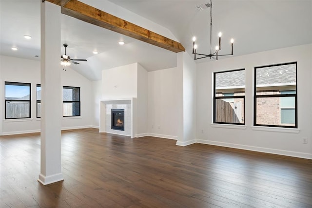 unfurnished living room with plenty of natural light, dark hardwood / wood-style floors, and ceiling fan with notable chandelier