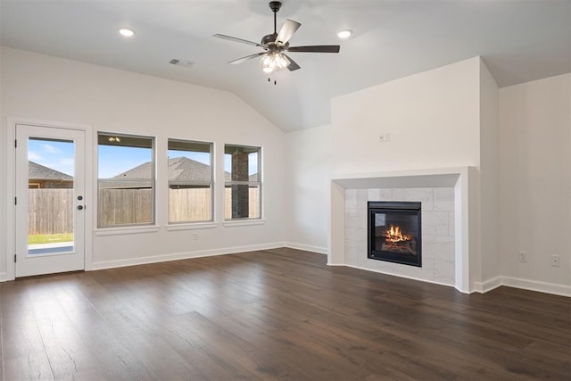 unfurnished living room with dark hardwood / wood-style floors, ceiling fan, lofted ceiling, and a fireplace