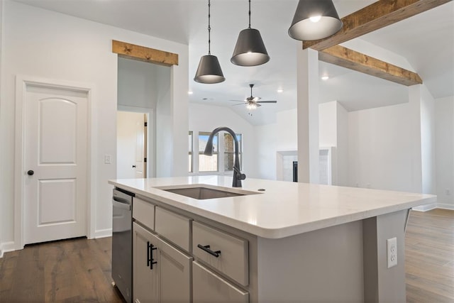 kitchen with dark hardwood / wood-style floors, sink, a kitchen island with sink, and decorative light fixtures