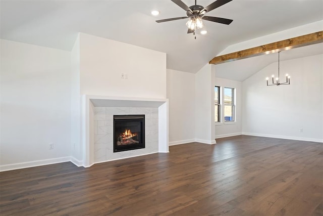 unfurnished living room featuring dark hardwood / wood-style floors, ceiling fan with notable chandelier, a tile fireplace, and vaulted ceiling