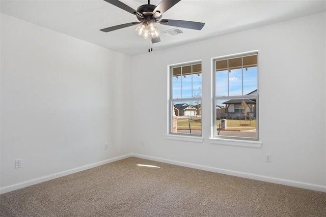 carpeted spare room with ceiling fan