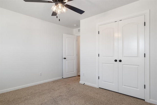 unfurnished bedroom with ceiling fan, a closet, and light colored carpet