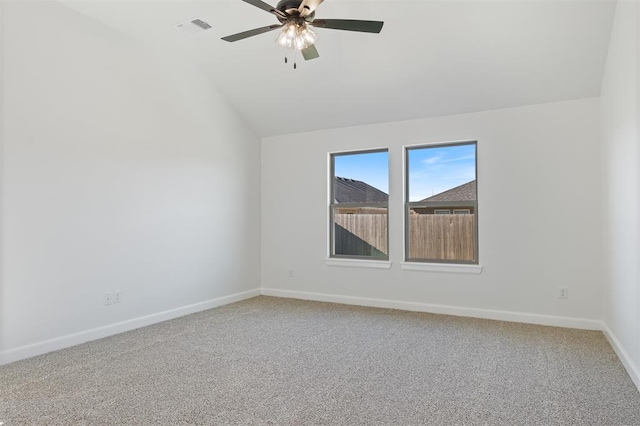 carpeted spare room with vaulted ceiling and ceiling fan