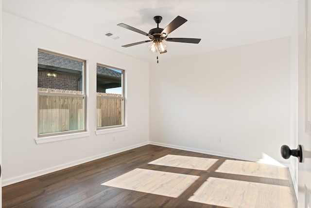 spare room featuring ceiling fan and dark wood-type flooring