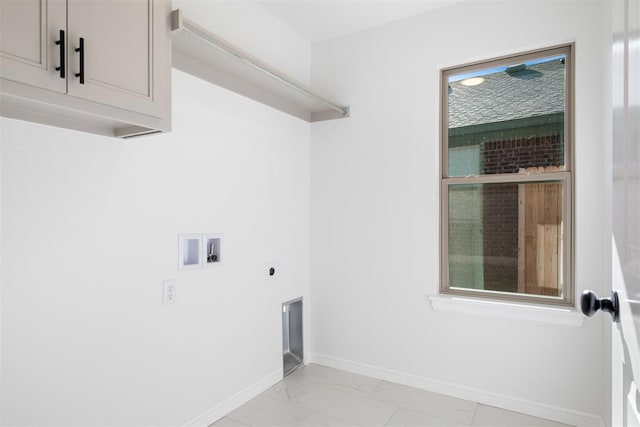 clothes washing area featuring electric dryer hookup, cabinets, and washer hookup