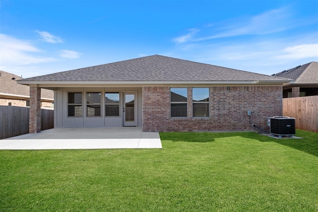 back of house featuring a lawn, a patio area, and central AC