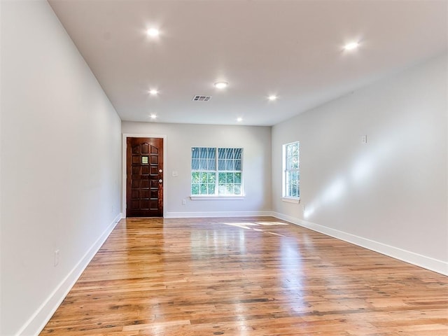 empty room with light hardwood / wood-style floors